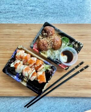 Japan Travel Guide: Everything You Need to Know for an Unforgettable Trip 11 A vibrant Japanese bento box with sushi rolls and takoyaki, perfect for a light lunch.
