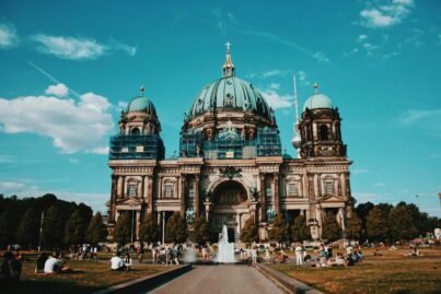 Captivating image of Berlin Cathedral against a vibrant blue sky, showcasing its architectural beauty.