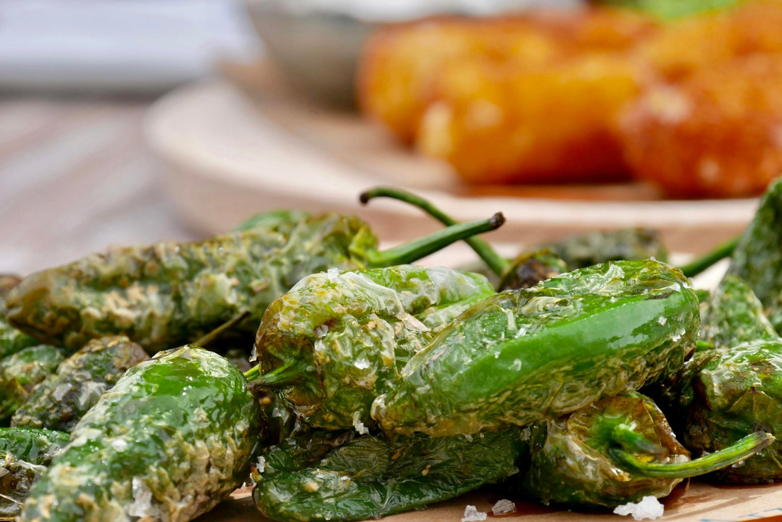 Spain Travel Guide: Things to know before travelling to Spain 17 Delicious close-up of roasted Padrón peppers sprinkled with salt, a classic Spanish tapa.