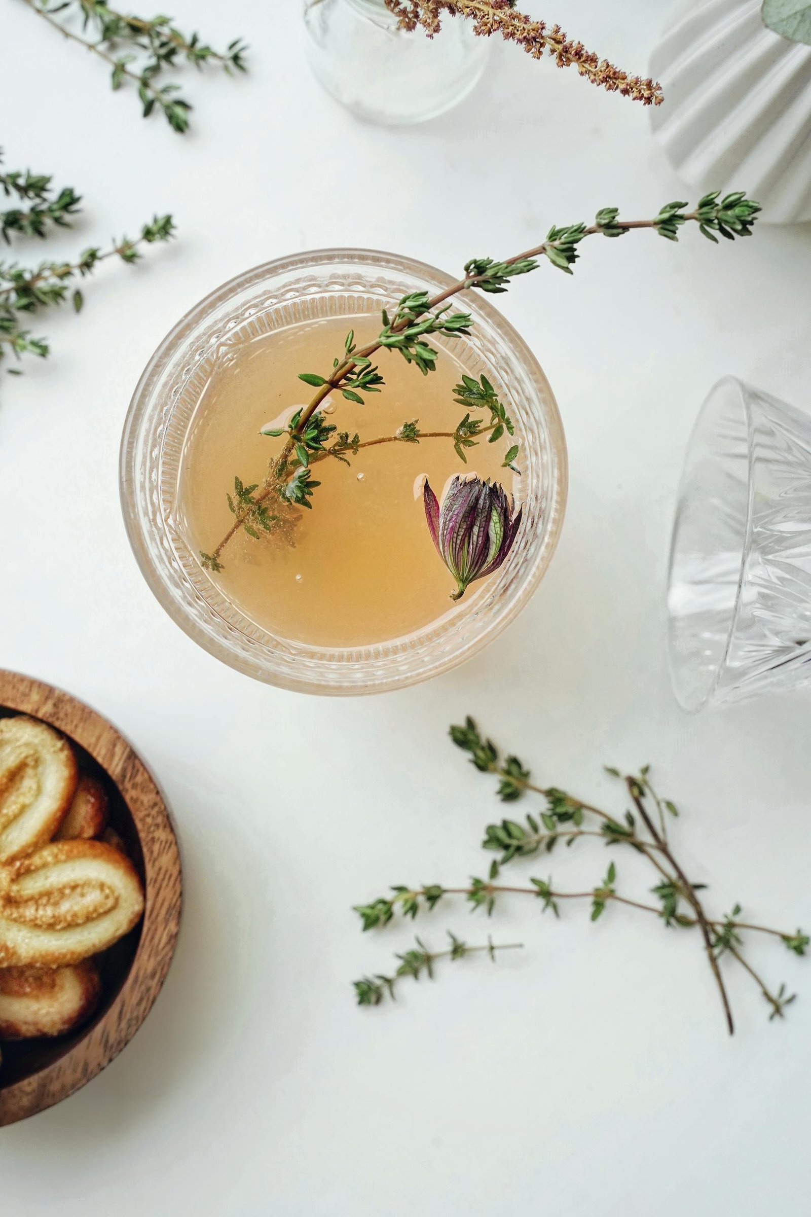 England Travel Guide for first time visitors 15 Elegant flatlay of herbal tea garnished with thyme and served with cookies, captured from above.
