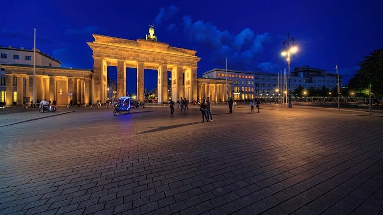 Stunning night view of Berlin's Brandenburg Gate lit up, seen during our Central Europe tour