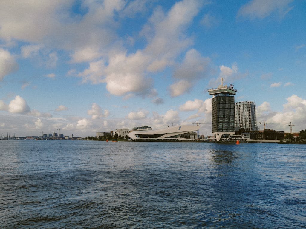 A beautiful day view of Amsterdam's skyline featuring the Eye Film Museum and A'DAM Tower.