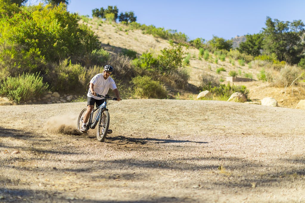 Getting around Saudi Arabia? Transport Tips for Tourists 10 A man enjoys biking on a dirt trail in sunny Santa Barbara, showcasing outdoor adventure and fitness.