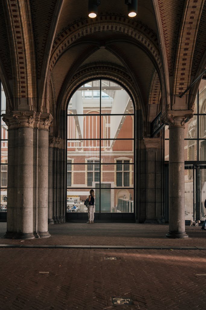 Elegant arched passage at the Rijksmuseum in Amsterdam offers a serene urban experience.