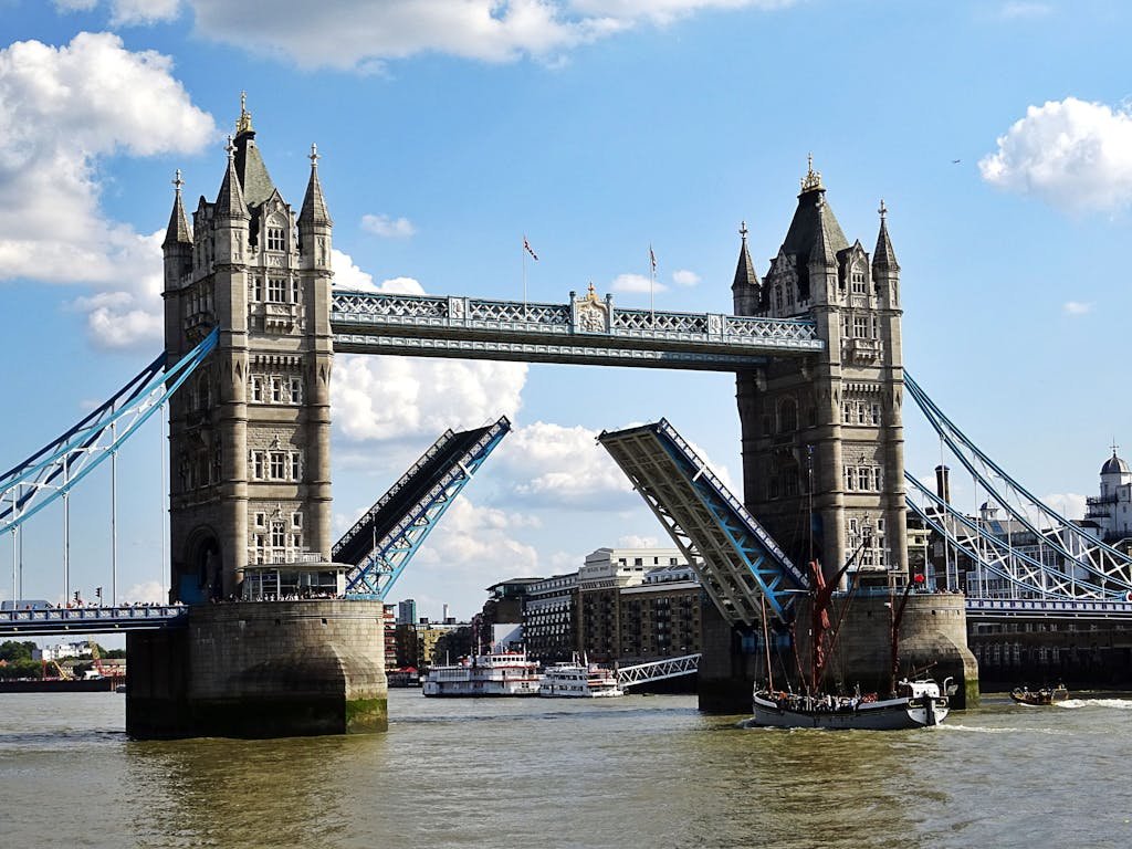 Iconic Tower Bridge in London with raised bascules over the River Thames free thing to experience if you want travel Europe on a budget