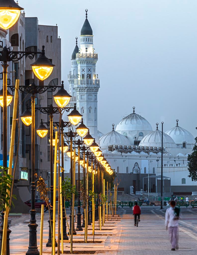 beautiful places in Saudi Arabia Illuminated street lights and iconic Quba Mosque domes in Riyadh, Saudi Arabia at dusk.