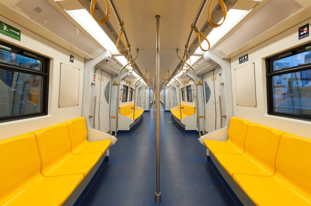 Getting around Saudi Arabia? Transport Tips for Tourists 6 Interior of a modern subway car with bright yellow seats and clean design, emphasizing public transportation.