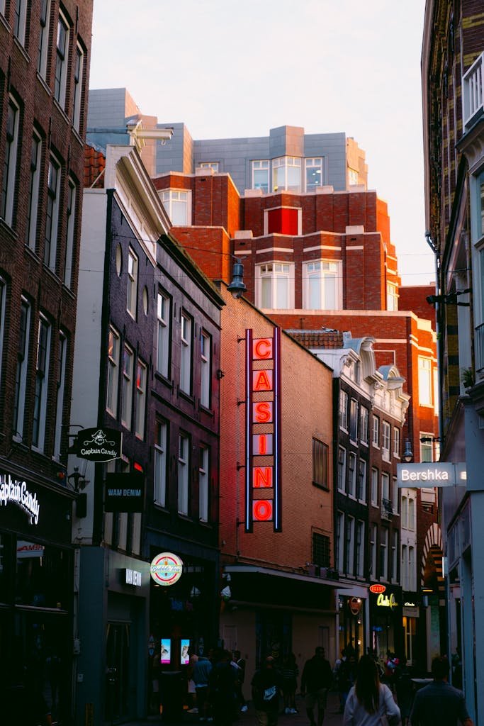 Lively downtown street featuring a prominent casino sign and bustling pedestrian activity at dusk.