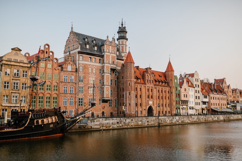 Scenic view of colorful historic buildings along the Motława River in Gdańsk, Poland.