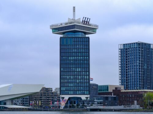 Scenic view of the iconic A'dam Tower against a cloudy Amsterdam skyline.