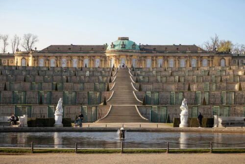 Steps leading to the grand Sanssouci Palace in Potsdam, Germany, captured in daylight.
