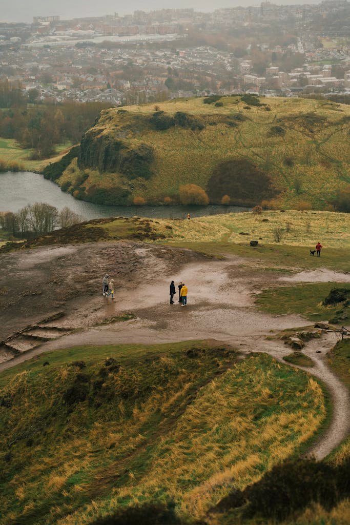 45 Unique Things to Do in Edinburgh: Hidden Spots & Must-See Attractions 23 A breathtaking view of Arthur's Seat in Edinburgh with hikers exploring the landscape.