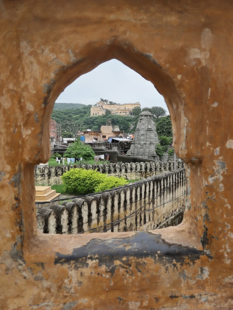 45 Unique Things to Do in Edinburgh: Hidden Spots & Must-See Attractions 32 A timeless view through a heritage window — capturing the harmony of the temple spires and the royal fort in the heart of Rajasthan.