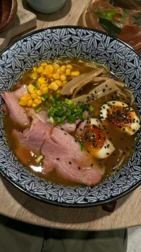 15 Best Chinese Restaurants in Paris (Authentic Flavors You’ll Love) 7 Appetizing bowl of ramen with duck, egg, corn, and vegetables in flavorful broth.