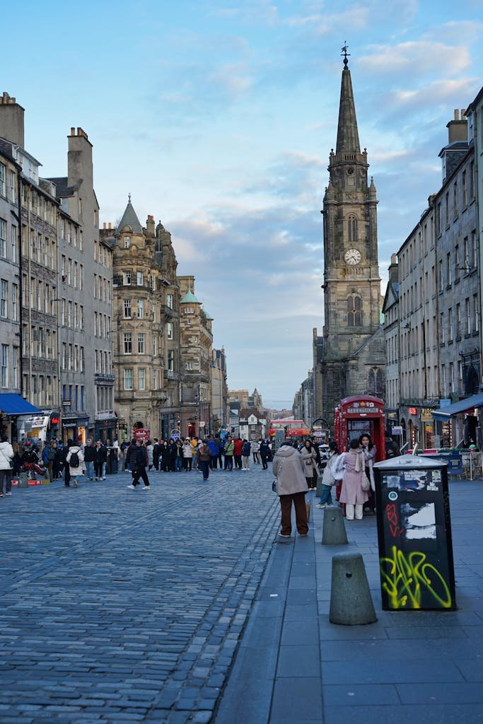 45 Unique Things to Do in Edinburgh: Hidden Spots & Must-See Attractions 3 Capture of the bustling Royal Mile in Edinburgh featuring historic stone buildings and a gothic clocktower.