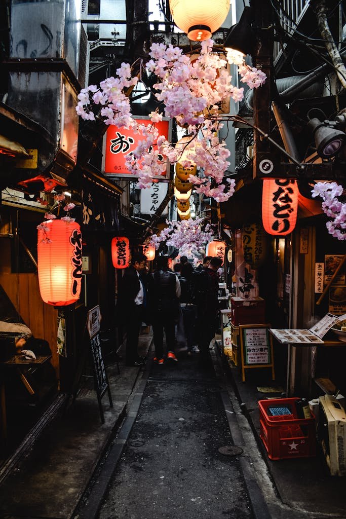 31 Best Things to Do in Tokyo, Japan 14 Explore a lively Japanese alley adorned with lanterns and cherry blossoms in an atmospheric street market.
