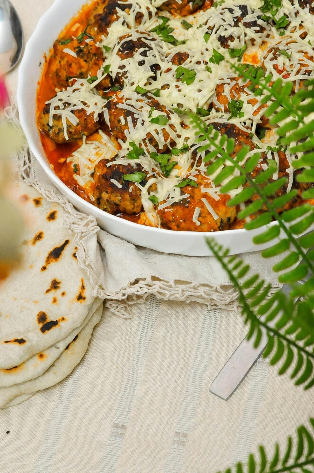 Mouthwatering meatballs topped with cheese in a rich tomato sauce. Perfect for family dinners.