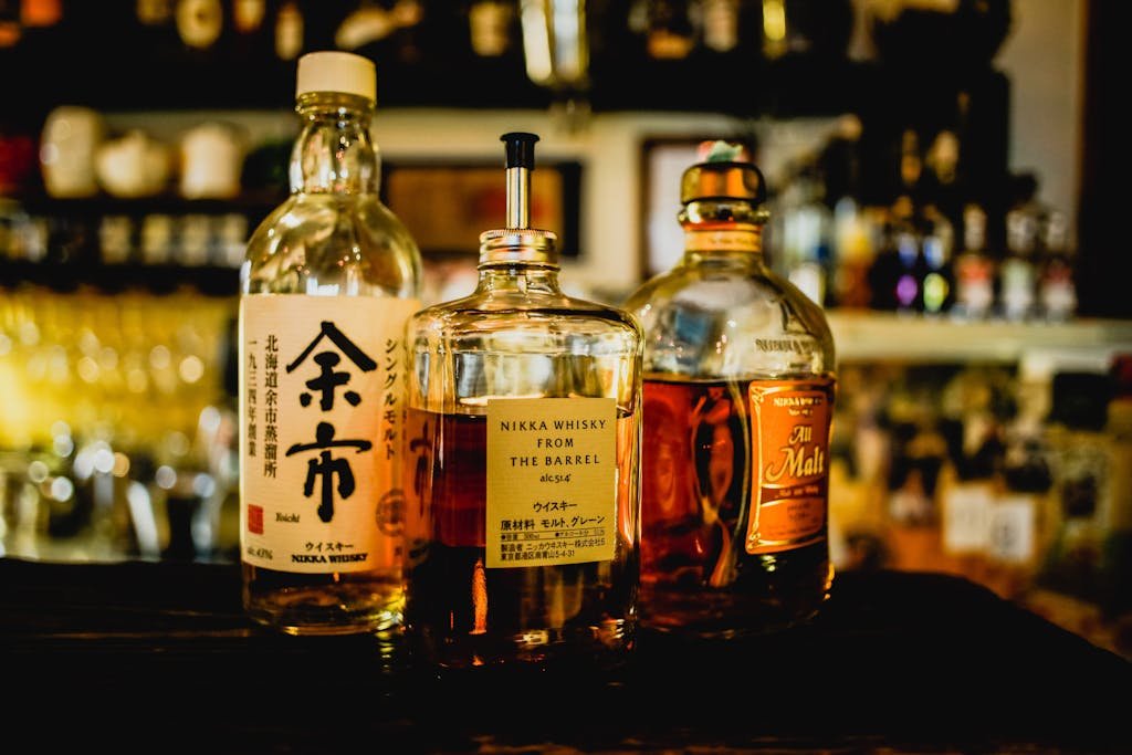 45 Unique Things to Do in Edinburgh: Hidden Spots & Must-See Attractions 29 Selection of Japanese whisky bottles displayed in a dimly lit bar setting.