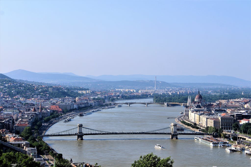 Breathtaking aerial view of Budapest with Chain Bridge and Danube River, showcasing urban beauty and architectural landmarks.