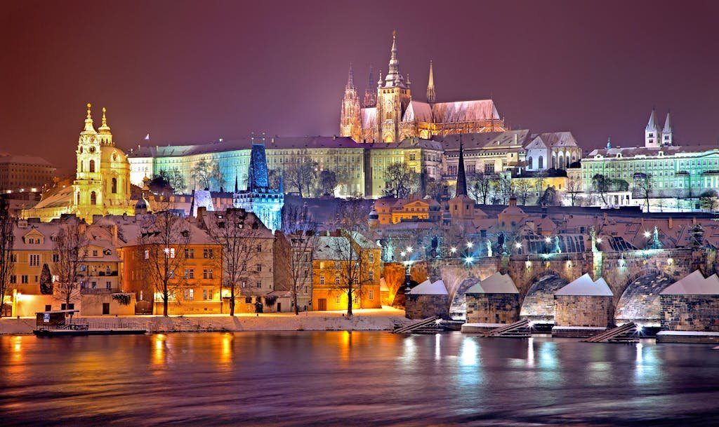 3 Magical Days in Prague (My Prague travel Itinerary) 7 Illuminated Prague Castle and Vltava River at night in winter. Capturing historic beauty.