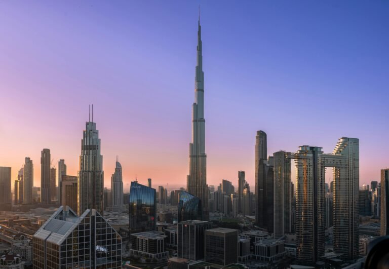 Dubai skyscrapers, including Burj Khalifa with a dawn sky background