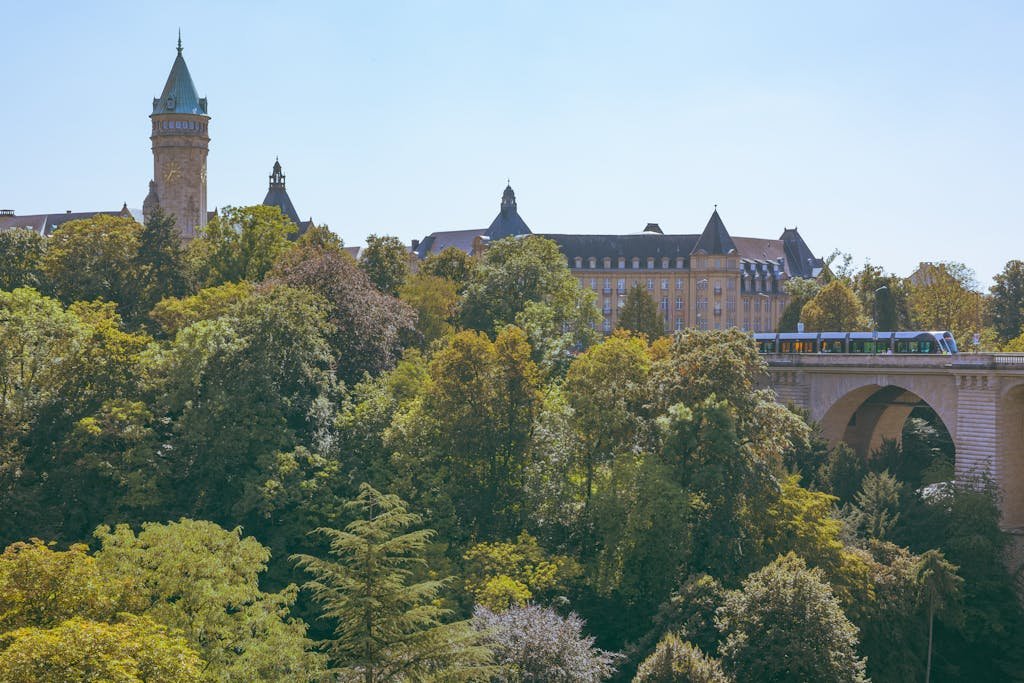 How to Spend 24 Hours in Luxembourg City? An In-Depth Guide 1 24 hours in Luxembourg Aerial view of Adolphe Bridge with lush greenery and historical buildings in Luxembourg City. Captivating urban landscape.