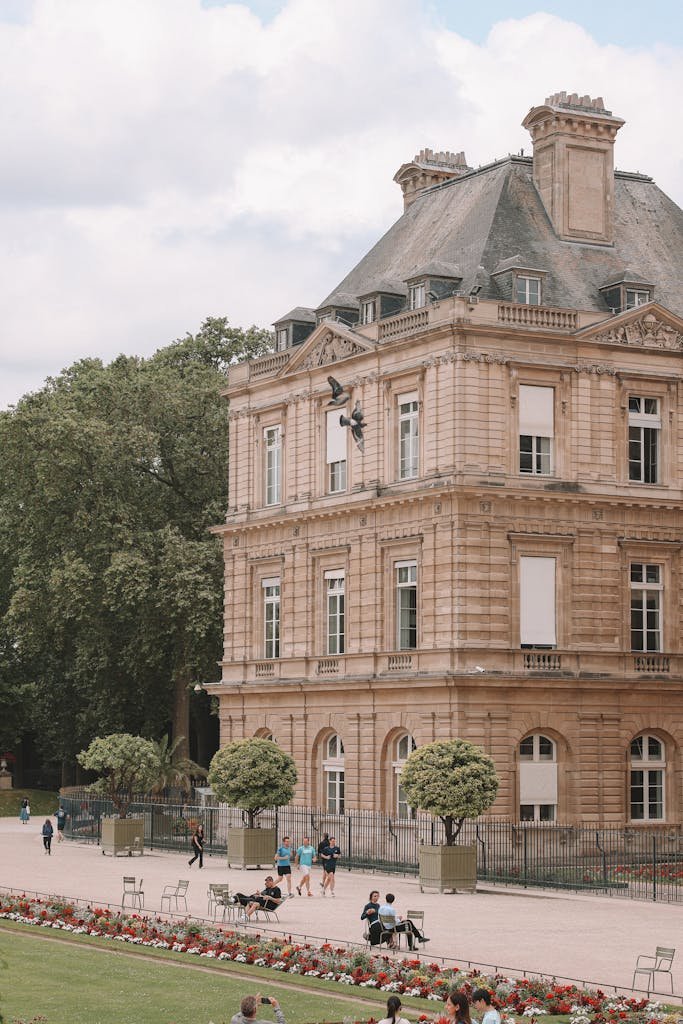 Elegant view of Luxembourg Palace and gardens in Paris, featuring classic architecture and serene park ambiance.