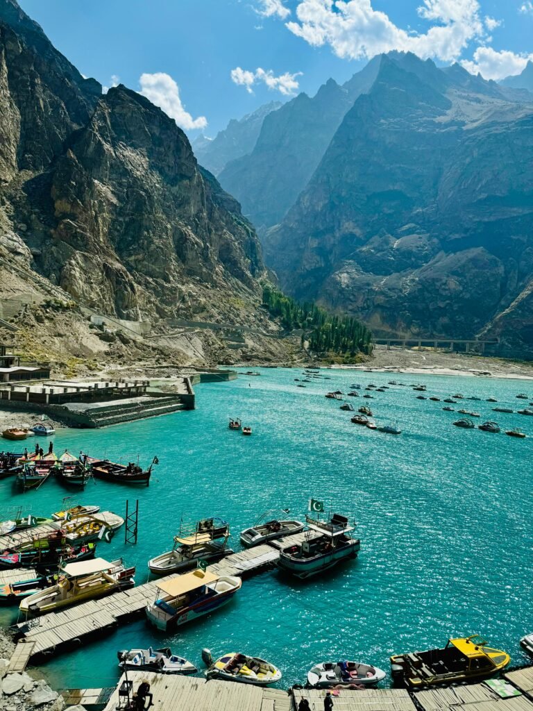 turquoise-blue wate lake surrounded by towering mountain peaks