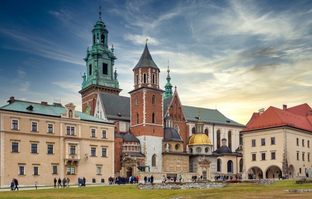 15 Cheapest Cities in Europe to Visit If You Love Traveling on a Budget 2 Old Roman Catholic cathedral and aged buildings in Krakow, Poland at sundown