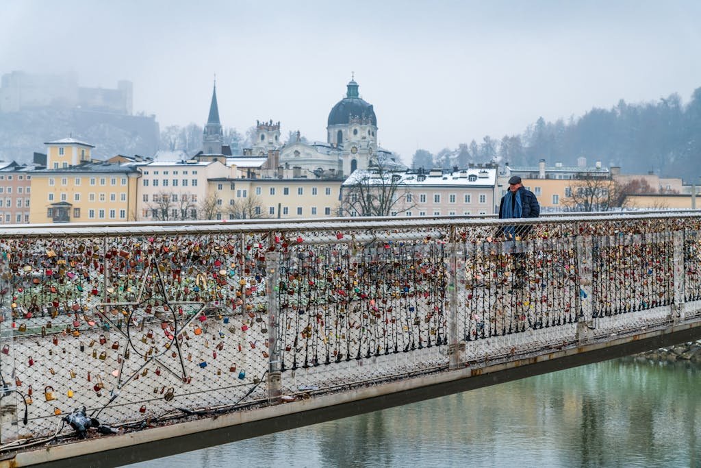 5 Days in Austria: The Perfect Austria Road Trip Itinerary 16 A man walks across the Makartsteg Bridge adorned with love locks in Salzburg, Austria.