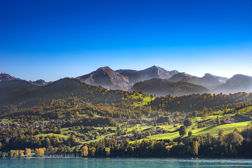 How to Spend the Perfect 5 Days in Switzerland Itinerary? 10 Breathtaking landscape of Spiez with Swiss Alps and Lake Thun in the backdrop. Ideal for nature enthusiasts.
