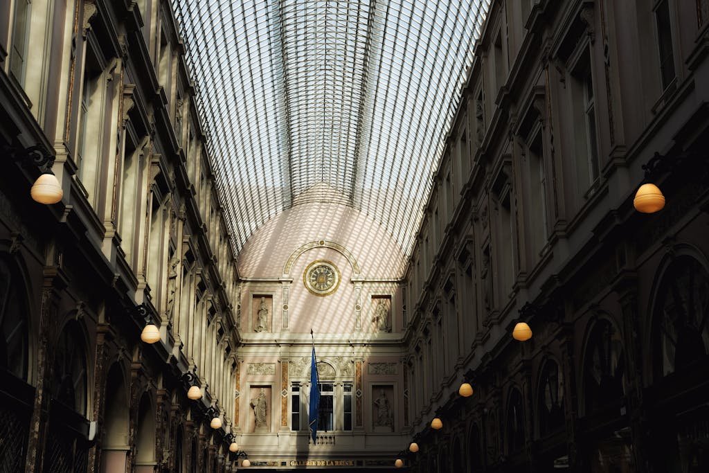 15 Best Things To Do In Brussels Belgium: Tips for first time visitors 4 Captivating view of Royal Gallery of Saint Hubert showcasing intricate architecture and sunlight through glass roof.