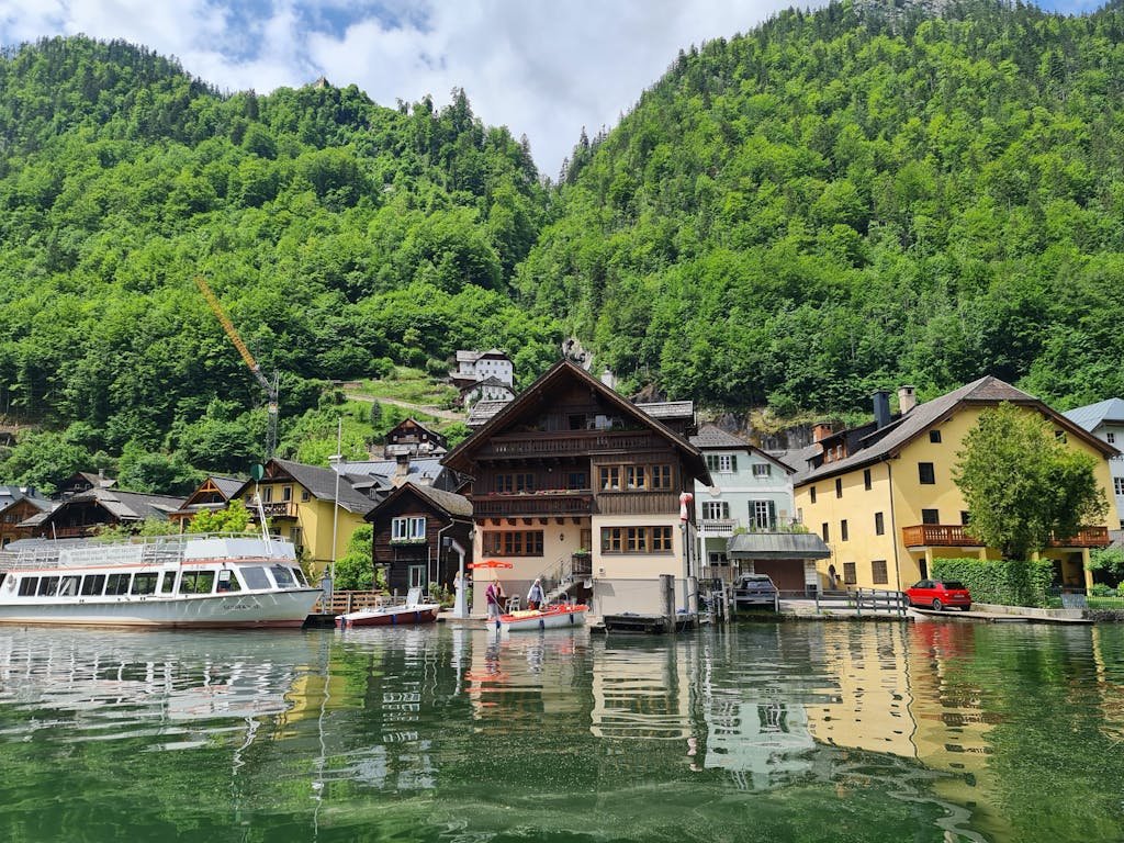 5 Days in Austria: The Perfect Austria Road Trip Itinerary 13 Charming lakeside village of Hallstatt with traditional houses, boats, and lush green mountains in summer.
