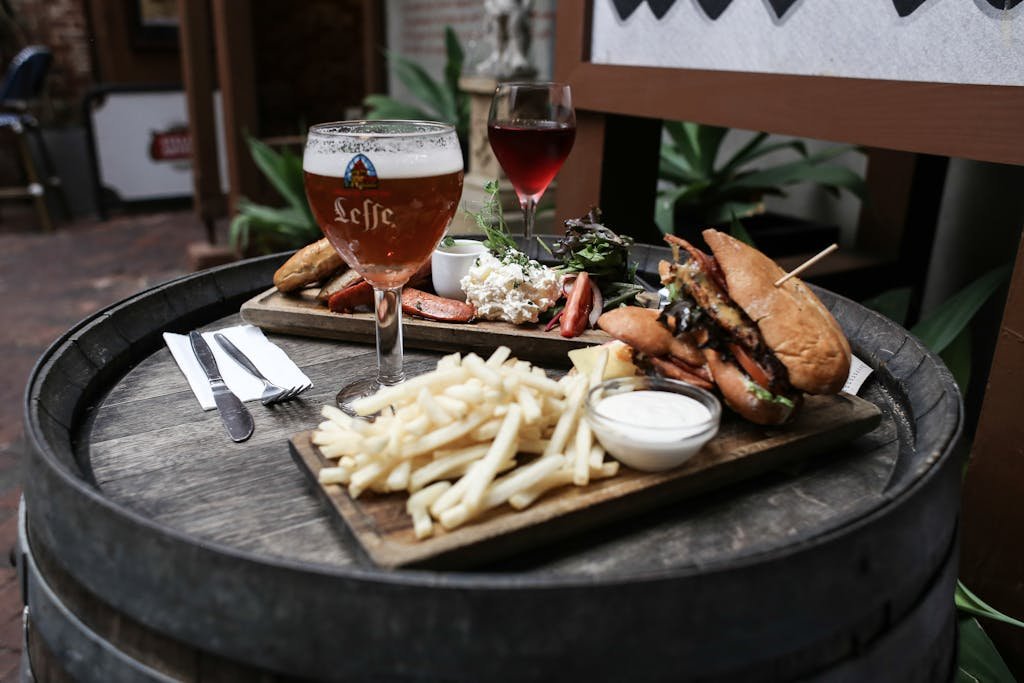 15 Best Things To Do In Brussels Belgium: Tips for first time visitors 17 Close-up of a gourmet meal with beer and wine, served on a rustic barrel table. Perfect for food lovers.
