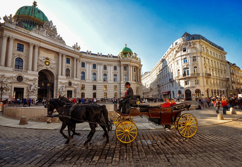 Horse-drawn carriage in front of the iconic Vienna Hofburg Palace, a popular tourist attraction during 5 days in Austria