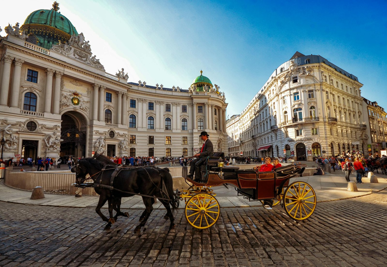 Horse-drawn carriage in front of the iconic Vienna Hofburg Palace, a popular tourist attraction during 5 days in Austria