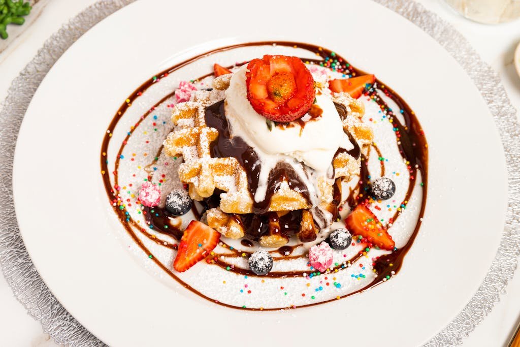 15 Best Things To Do In Brussels Belgium: Tips for first time visitors 9 Indulgent Belgian waffles topped with chocolate, strawberries, and whipped cream.