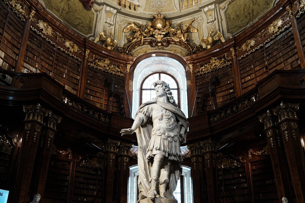 5 Days in Austria: The Perfect Austria Road Trip Itinerary 9 Stunning view of a grand statue in the Austrian National Library's baroque hall.