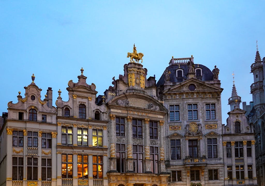 15 Best Things To Do In Brussels Belgium: Tips for first time visitors 2 Stunning view of ornate facades at Grand Place, Brussels during twilight. A UNESCO World Heritage Site.