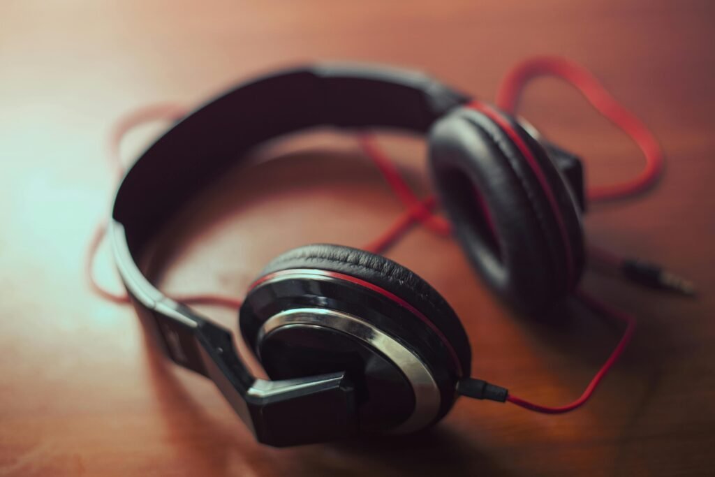 Black and red headphones placed on brown table