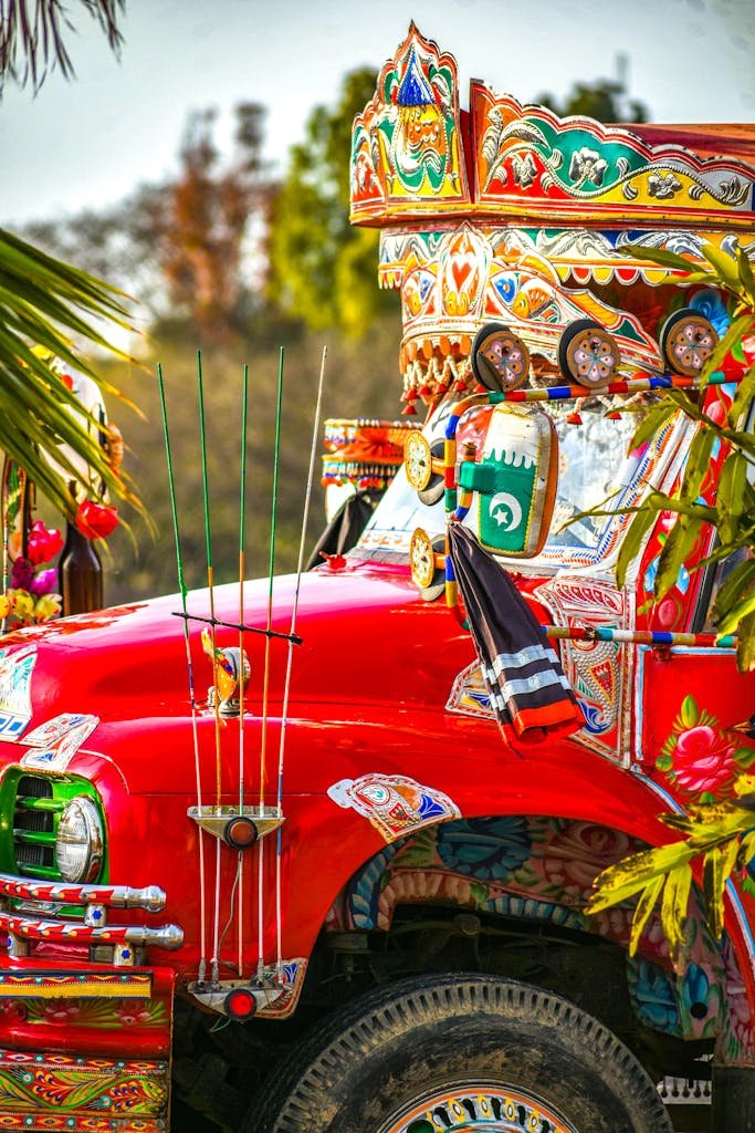 A beautifully decorated truck showcasing vibrant traditional designs during a festival.