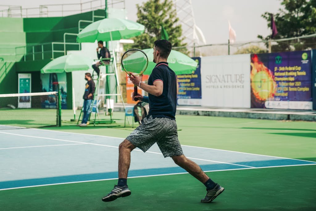 A male athlete playing tennis on a sunny day in Islamabad, Pakistan.