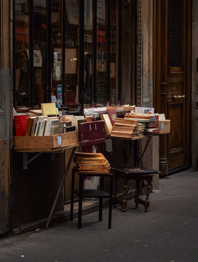 41 best Things to Do in Paris: Iconic Sights to Hidden Gems 19 A quaint outdoor book display at a Parisian bookshop on a historic street.