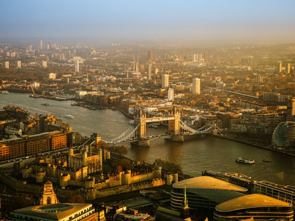 A stunning aerial view of London with Tower Bridge and the Thames at sunset.