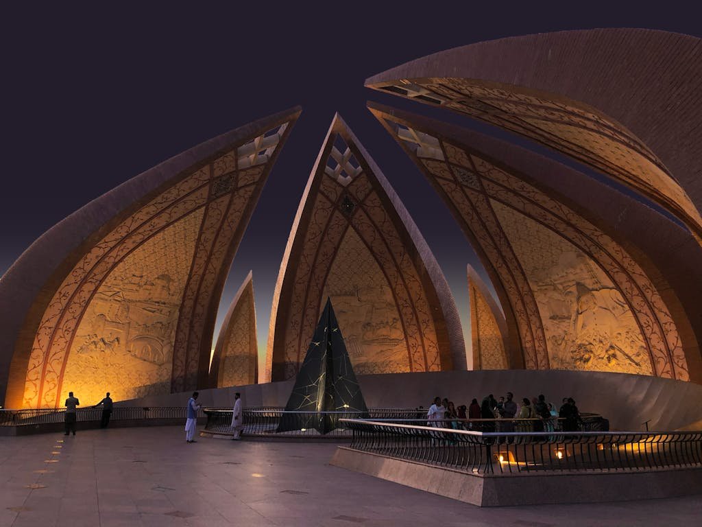A stunning night-time capture of the iconic Pakistan Monument in Islamabad, a symbol of national unity.