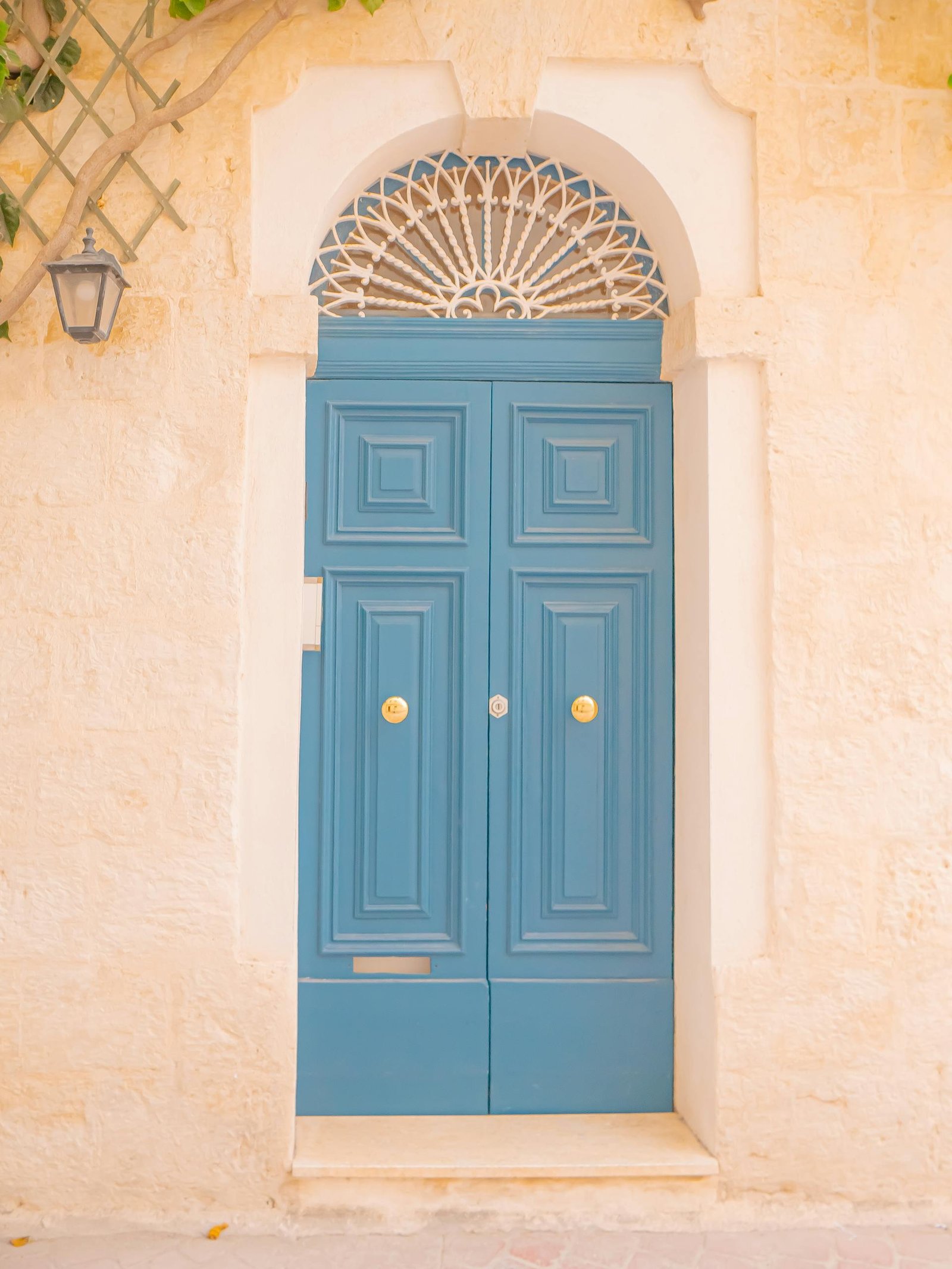 21 Best things to do in Mdina, Malta's Silent City 9 Blue door with architectural details on a limestone building in Malta's historic old town.