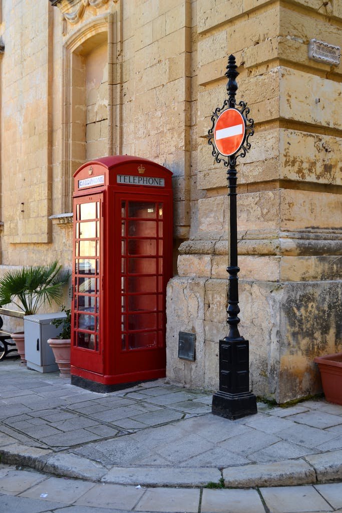 21 Best things to do in Mdina, Malta's Silent City 2 Classic red phone booth and street signs in Mdina, Malta's historic streets strolls, one of the best things to do in mdina a malta