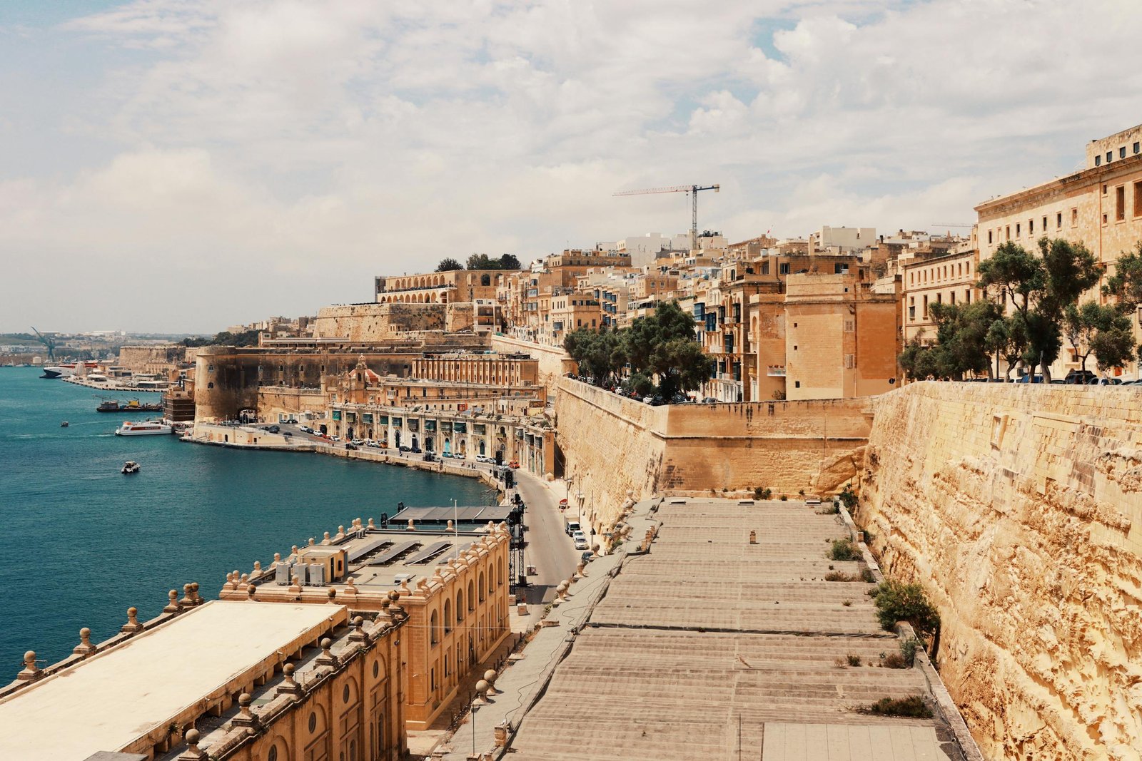 Explore Valletta's stunning waterfront with historic architecture and the serene harbor view.