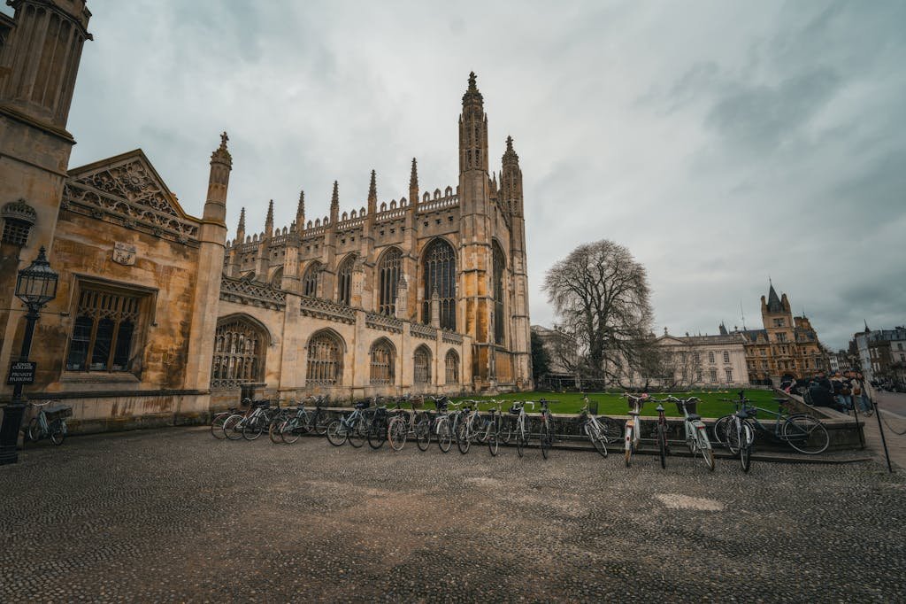 King's College Chapel with bicycles lined up in front, offering a classic Cambridge scene on a cloudy day.
