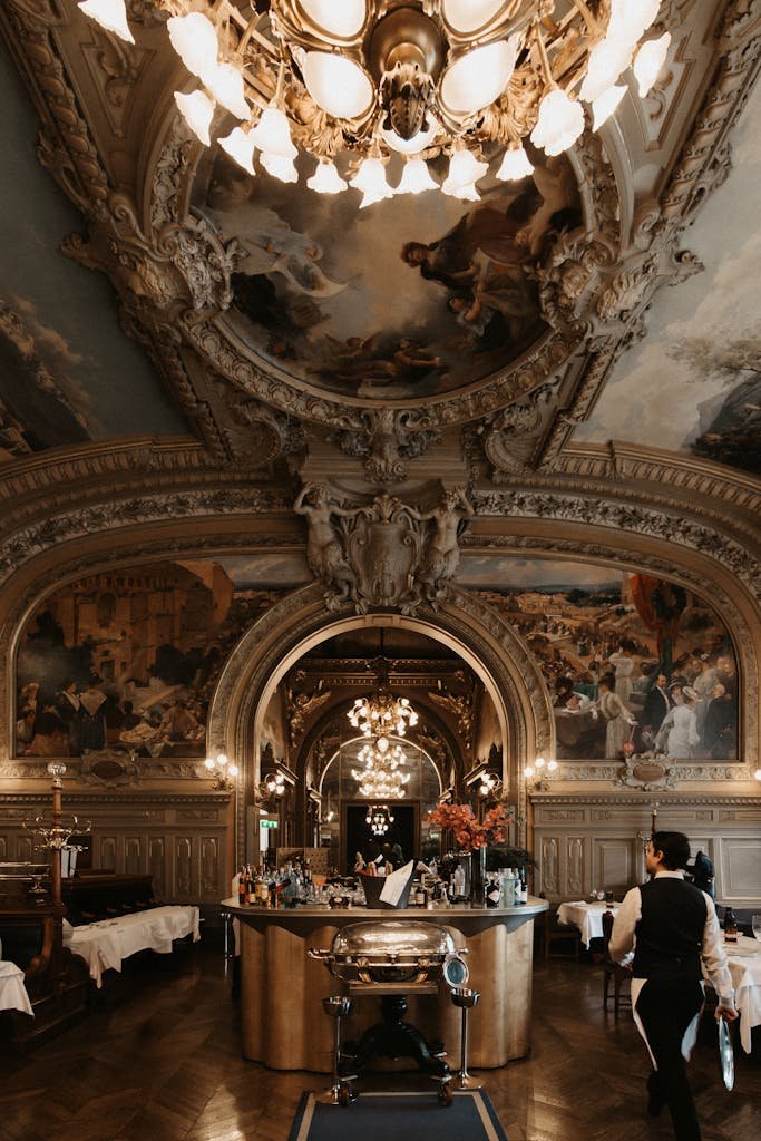 41 best Things to Do in Paris: Iconic Sights to Hidden Gems 22 Luxurious dining room of Le Train Bleu with ornate ceiling and chandeliers in Paris.
